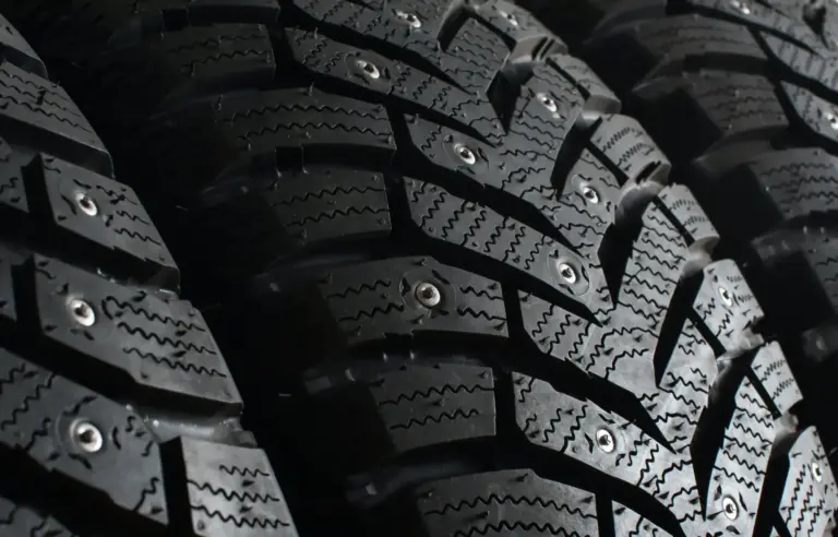 Winter tires with spikes for a car close up